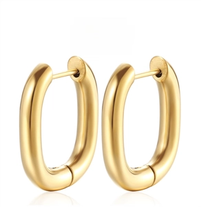 Detailed macro view showing hand-polished mirror finish on gold U-shaped earrings
