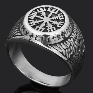 Macro shot of Viking Vegvisir ring in antique silver with Norse runes on black background