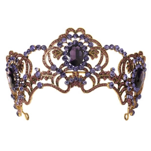 Detail of vintage Baroque crown with gold frame and vibrant purple crystal gemstones