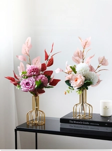 Modern gold metal wire frame vase with glass tube and purple roses for home decor