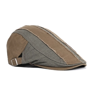 Detail of retro newsboy cap with distressed patchwork and adjustable metal side buckle