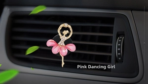 Close-up of dancing girl car air vent clip with pink flower petals and rhinestones