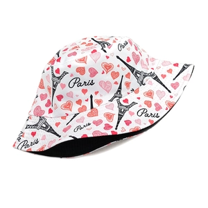 Detailed close-up of bucket hat with Eiffel Tower prints and black interior lining