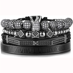 Close-up of black layered men's bracelets with crown charm and Roman numeral details