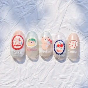 Close-up of cartoon bear nail stickers set with matte beige and glitter finishes