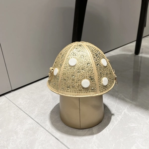 Detailed view of mushroom shaped handbag with sparkling rhinestones and white bead accents