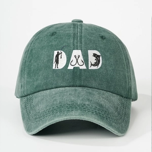 Detail of DAD embroidery with fishing elements on vintage green washed cotton baseball cap