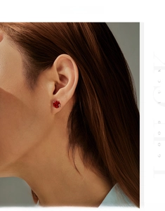 Detail view of 8mm rose-cut red crystal stud earring on ear with dimensions display