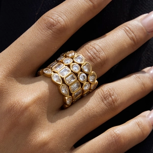 Detailed view of stacked 18K gold stainless steel rings with sparkling heart-shaped zircons