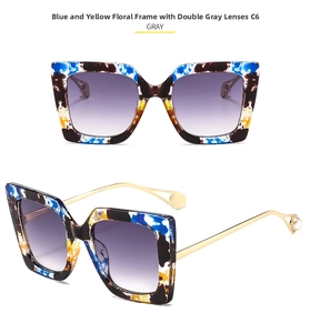 Detail of oversized floral tortoise sunglasses with gold temples and pearl accents
