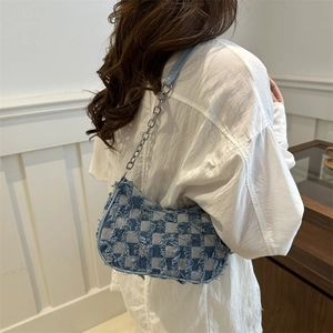 Denim checkerboard shoulder bag with distressed fringe and silver chain strap for women