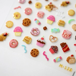3D dessert nail stickers with donuts and cupcakes on white background H-529