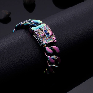 Macro view of a colorful Cuban chain bracelet featuring a skull charm on black leather