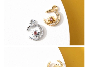 Detail of moon and star charms with sparkling rhinestones in gold and silver finishes
