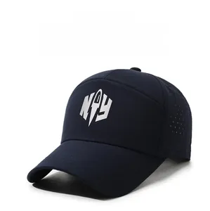 Detail view of breathable laser-cut holes and silver letter logo on navy baseball cap