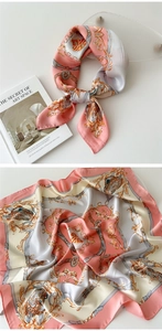 Detail view of pink and gold silk scarf with classical baroque chain and emblem patterns