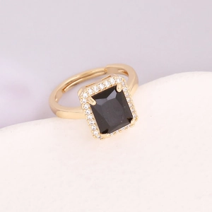 Detailed view of rectangle black gemstone ring with micro-paved cubic zirconia halo
