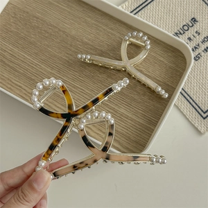 Cross tortoise shell shark hair clip with gold metal frame and pearl embellishments