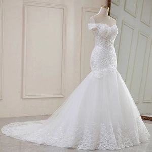 Detailed side view of off-shoulder lace mermaid wedding dress with long sequined train