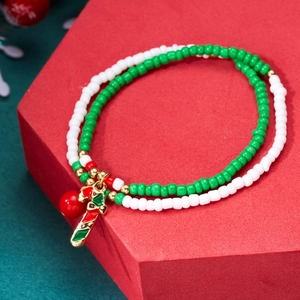 Detail of Christmas beaded bracelets with green and white beads and candy cane charms