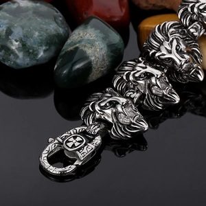 Detailed macro view of silver lion head bracelet with stainless steel cross clasp