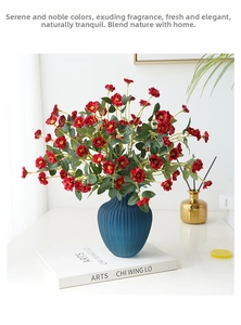 Deep blue textured ceramic vase with vibrant red artificial wild roses for home decor