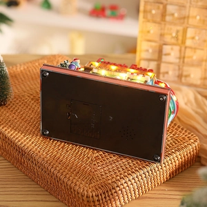 Detailed bottom view showing the battery compartment and non-slip pads of Christmas music box