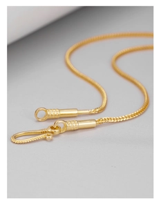Detail of a golden herringbone chain showing the intricate S-hook clasp and metal texture