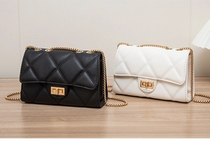 Detail view of black and white quilted chain bags with gold hardware and flap locks