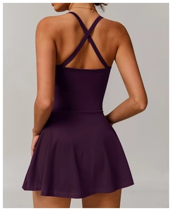Detail of cross-back straps and open back design on a dark purple tennis dress
