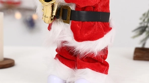 Close-up of Santa Claus toy holding a golden saxophone with soft red plush fabric texture
