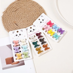 Macro view of butterfly hair clips in colorful matte and transparent finishes