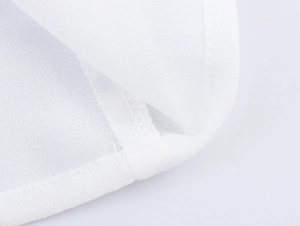 Detailed close-up showing the professional hem stitching on white chiffon blouse fabric