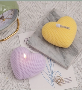 Detail of heart-shaped scented candles with honeycomb texture in lavender and yellow
