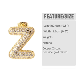 Macro shot of gold-plated Z-letter earring with zircon stones and sizing info