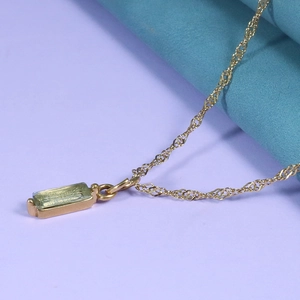 Detail of gold Singapore chain necklace with rectangle light green zircon stone pendant