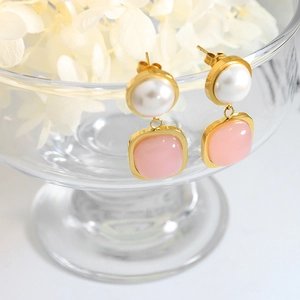 Elegant gold earrings with round white pearls and soft pink gemstone pendants