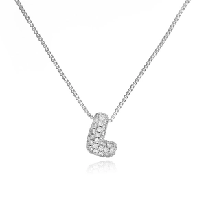 Macro shot of silver letter L pendant with pavé cubic zirconia on a delicate box chain