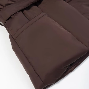 Detail showing smooth brown polyester fabric and large patch pocket on the jacket