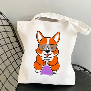 White canvas tote bag with cartoon Corgi print resting on a black wire chair