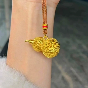 Detailed view of 24k gold plated gourd pendant with traditional filigree leaf texture