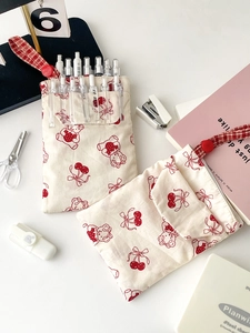 Cute bunny nurse pencil case in cream fabric with red patterns and stationery props