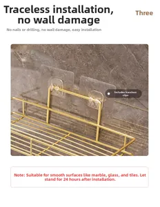 Detail of golden iron bathroom shelf showing mesh design and adhesive hooks on marble wall