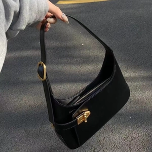 Chic black leather underarm bag with gold metal clasp and minimalist urban design