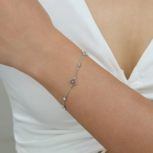Elegant S925 sterling silver four-leaf clover bracelet on model wrist with polished beads