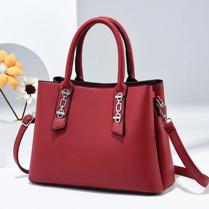Elegant red leather handbag for women featuring silver chain accents and a removable strap