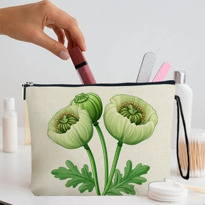 Trousse à maquillage en toile à motif pavot vert avec fermeture éclair sur une coiffeuse