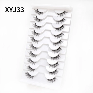 Detailed 45-degree angle of 10 pairs of natural cat-eye thick false eyelashes on white tray