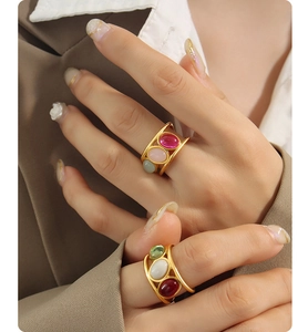 Detailed macro of vintage 18K gold plated rings with colorful oval gemstones for women