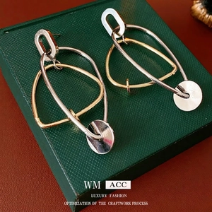 Minimalist irregular geometric dangle earrings in polished gold and silver metal